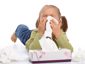 Child sneezing because of allergies caused by poor Indoor Air Quality